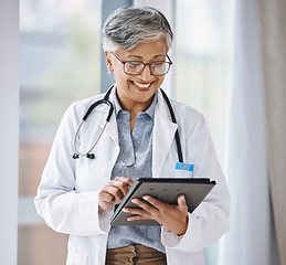 Image showing Senior doctor, woman with tablet and digital medical results with hospital schedule and healthcare information online. Happy female physician, health insurance and professional in medicine with tech