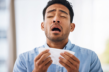 Image showing Sick, sneeze and man with a tissue, allergies and sickness with symptoms, cold and illness. Male model, person and guy with congested with sinuses, toilet paper for nose and fever with health issue