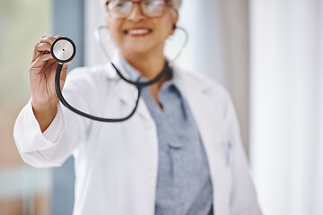 Image showing Woman doctor, stethoscope and cardiologist in hospital for a heart health and wellness consultation. Professional female with healthcare or cardiology tool in hand for medical exam, checkup or care