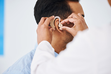 Image showing Doctor, man and hearing aid on ear for medical support, wellness and innovation of disability. Closeup, healthcare worker and deaf patient with audiology implant, service and help for sound waves