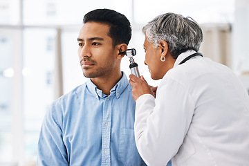 Image showing Doctor check patient ear, consultation and healthcare, people at hospital with otolaryngology specialist. Man and senior physician woman with otoscope test for hearing problem and health insurance