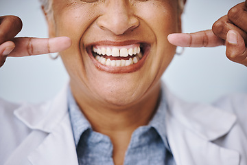 Image showing Dental, hand and pointing by elderly woman in studio for mouth, hygiene or denture care on grey background. Teeth whitening, cleaning and senior lady happy for oral, tooth and natural looking veneers