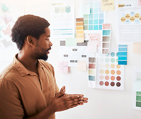 Image showing Black man, color palette and planning in design, brainstorming or strategy on wall at office. Thoughtful Creative African male graphic designer looking at colors or ideas for project plan or startup