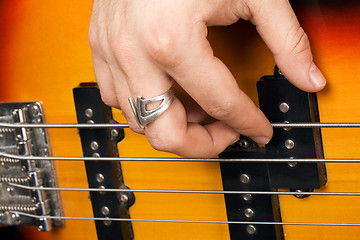 Image showing Hand of the guitarist on guitar strings