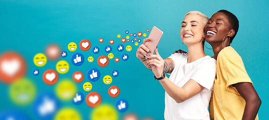 Image showing Women, social media icons or friends take a selfie for content or online post on blue background. Love emojis, diversity or happy girls take pictures together on mobile app website or digital network