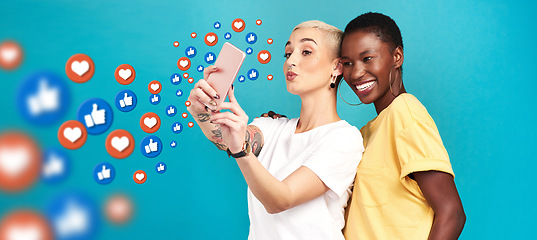 Image showing Diversity, social media icons or women take a selfie for content or online post on blue background. Love emojis, friends or happy girls take fun pictures together on mobile app or network in studio