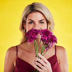 Image showing Portrait, smell and woman with flowers, beauty and confident girl against a studio background. Face, female person and model with plants, natural care and floral present with lady, bouquet and scent