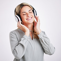 Image showing Music, smile and happy woman in studio with headphones for audio track on grey background. Radio, relax and excited female with earphones for podcast, playlist and online, streaming and subscription