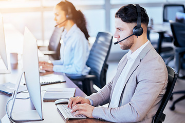 Image showing Call center, computer and typing man in office for customer service, technical support and help desk. Telemarketing, contact us and communication with employee for sales advice, operator or crm focus