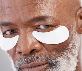 Image showing Skincare, eye mask and zoom on portrait of man with serious face and professional anti ageing spa treatment. Dermatology, cosmetic collagen routine and mature African model with skin care on eyes.