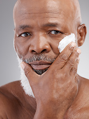 Image showing Beauty, cream and portrait of senior black man for wellness, skincare and facial care in studio. Dermatology, wellness and serious male person with lotion for anti aging, wrinkle and face moisturizer