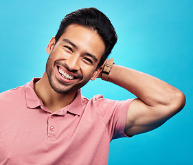 Image showing Smile, happy and portrait of Asian man on blue background with pride, confidence and happiness. Fashion, confident and face of isolated male in studio with style, relaxing and excited expression