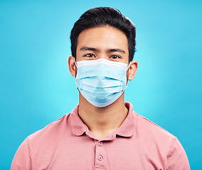 Image showing Man in face mask, portrait and covid with safety from virus, bacteria and germs isolated on blue background. Disease, corona and male person, health compliance and rules with protection in studio