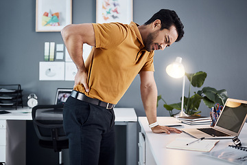 Image showing Night, back pain and business man with stress at office desk in a modern workplace. Professional asian male person with health, body ache or burnout problem while tired, injured and working late