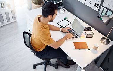 Image showing Laptop, working and business man typing internet, web or online research for multimedia design, project process or development. Office top view, html website and male designer working on web graphic