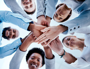 Image showing Business people, hands stack and teamwork in low angle, team building and trust. Solidarity, huddle and happy group or staff of men and women with hand together for motivation, synergy and support.