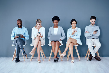 Image showing Business people, networking and technology in waiting room for interview, meeting or job search at office. Diversity group of employees sitting in row for recruitment process, collaboration or hiring