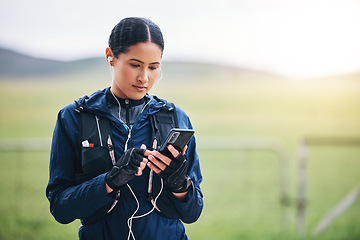 Image showing Music, phone and woman in the countryside ready for fitness and exercise with mockup. Sports, training and mobile headphones of a female athlete looking at gps with audio and web radio for workout