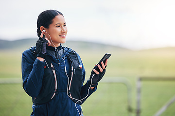 Image showing Music, phone and woman smile in the countryside ready for fitness and exercise with mockup. Sports, training and mobile headphones of a female athlete with internet audio and web radio for workout
