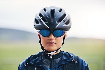 Image showing Portrait, cycling or girl athlete in nature for exercise, workout or training for triathlon sports or fitness. Woman cyclist, helmet gear or face of biker on break exercising for cardio endurance