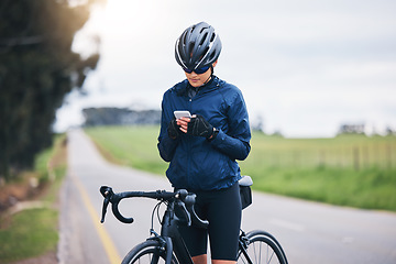 Image showing Woman, bicycle athlete and outdoor with phone for social media technology, mobile app or search gps direction. Female cyclist, bike and typing on smartphone for network notification, sport or cycling