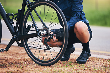 Image showing Person, bike and wheel repair outdoor for training, triathlon sports and transportation problem. Closeup of athlete, bicycle and check tire chain for travel safety, cycling maintenance and fixing hub