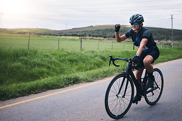 Image showing Fitness, win and woman in celebration while cycling in nature with energy for a race, marathon or competition. Sports, workout and female athlete cyclist cheering for cardio exercise on outdoor road.