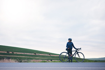 Image showing Sports, woman and bicycle in countryside with sky mockup, athlete and thinking of cardio training goals. Female cyclist, bike and fitness with copy space, freedom and cycling performance in triathlon