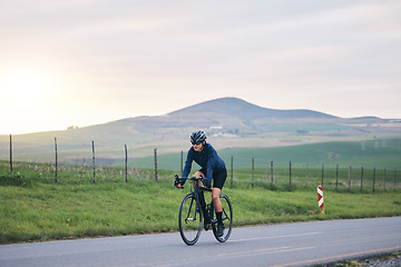 Image showing Sports, mountain and woman cycling in the road while training for a race, competition or marathon. Fitness, health and female athlete cyclist doing a cardio exercise or workout with bicycle in nature