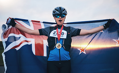 Image showing Winner sports, happy woman and flag with gold medal for winning outdoor cycling race or New Zealand triathlon. Happiness, win and success cyclist in wow, fitness and world record with national pride.