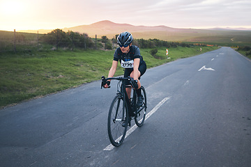 Image showing Fitness, cycling and woman athlete on a mountain while training for a race, competition or marathon. Sports, cycle and female cyclist doing a cardio exercise or workout with bicycle in road on a hill