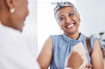 Image showing Happy, medical and a woman customer in a pharmacy for medicine, talking to a professional consultant. Smile, healthcare and a mature female patient chatting to a pharmacist in a clinic or dispensary