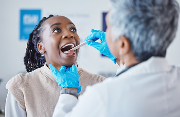 Image showing Consultation, doctor and patient with tongue depressor, open mouth pain and healthcare advice at clinic. Black woman consulting medical professional, health care check and tonsil exam at hospital.