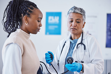Image showing Consultation, doctor and patient with blood pressure test and healthcare advice at clinic. Black woman consulting female medical professional, health care check and expert support or help at hospital