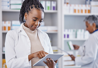 Image showing Black woman, doctor and tablet for inventory inspection at pharmacy for healthcare, medication or prescription stock. African female medical expert checking data or research on technology at clinic