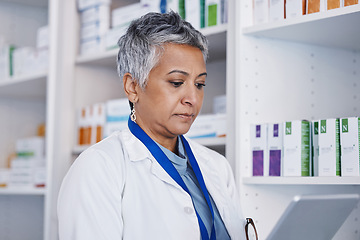 Image showing Senior woman, pharmacist and reading tablet for healthcare, medicine or inventory check at store on app. Female pharma expert, mobile touchscreen and focus for online order, service or prescription