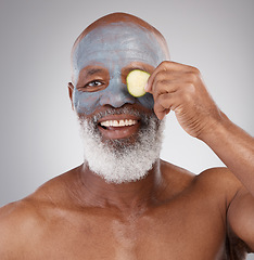 Image showing Face mask, cucumber and black man with smile in portrait, beauty and skincare isolated on studio background. Happy senior male, cosmetics and healthy skin, anti aging cosmetic routine with facial