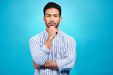 Image showing Portrait of man with focus, blue background and thinking of ideas with serious face isolated on studio backdrop. Confidence, mockup space and professional male model with pride and vision for future.