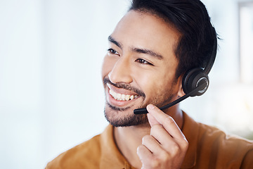 Image showing Asian man, call center and smile with headphones for customer service, consulting or support at office. Happy male consultant or agent smiling in telemarketing with headset for online advice or help