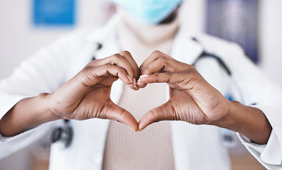 Image showing Doctor, hands and heart sign for healthcare or love and care for career as medical worker in hospital. Hand gesture of woman to show support, hope or emoji for charity, cardiology or health insurance