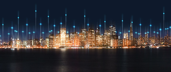 Image showing City, night and skyline by water with tech, network or light overlay for connection, iot or mockup space. Dark metro, cbd and skyscraper by ocean for development, infrastructure or futuristic mock up