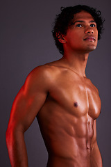 Image showing Light, strong and man chest in a studio with art lighting and thinking with muscles and fitness. Focus, isolated and gray background of an attractive male model with artistic, and shirtless spotlight