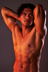 Image showing Man, sexy and torso body in studio for art, fitness or beauty of a person on a dark background. Face, strong muscle and male model with a six pack, glow and creative motivation for aesthetic backdrop