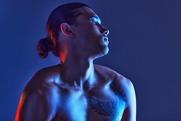 Image showing Man, sexy body and light in studio for art, fitness or beauty of a person on a blue background. Face, strong chest and fitness model with a tattoo, glow and creative motivation for aesthetic backdrop