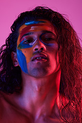 Image showing Beauty, cosmetics and portrait of man with paint for creative art, makeup and glow on studio background. Neon lighting, skincare and color on face of male model for fantasy, abstract and aesthetic