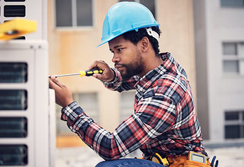 Image showing Black man, technician and maintenance with engineering and ac repair with handyman working with tools on roof. Fix air conditioner, male electrician with screwdriver and power generator with service