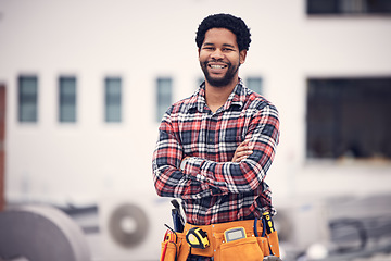 Image showing Construction worker, portrait and man on a building roof for architecture and property management. Smile, happiness and industrial designer with arms crossed and sustainable energy with motivation