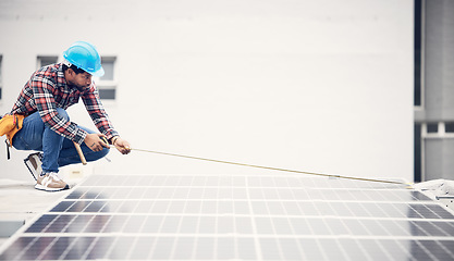 Image showing Man, solar panel and tape measure for roof maintenance of photovoltaic plate, eco friendly sustainable grid or renewable energy. Inspection, green power supply or male engineer check electricity cell