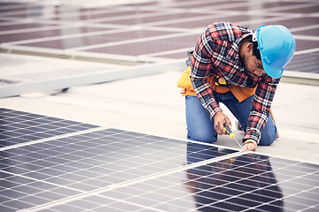 Image showing Black man, electrician and solar panels installation on rooftop, sustainable energy with eco friendly technology. Maintenance, tools and male in engineering with infrastructure and power from the sun