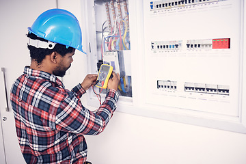 Image showing Electrician multimeter, electric switch box and man test cable system, wiring or measure voltage power supply. Quality control inspection, African repair person and technician electricity maintenance